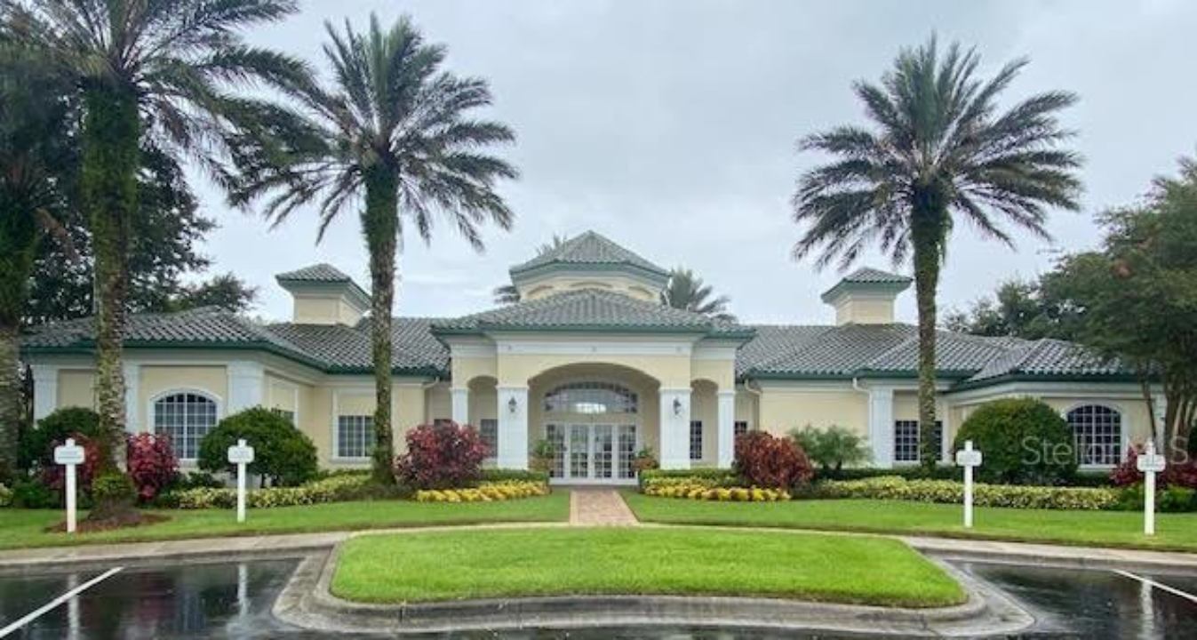 A large building with palm trees in front of it.